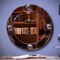 Round brass mirror with magnifying glass
